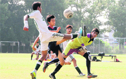 Players in action during a football match in Dehradun on Wednesday. Tribune photo: Vinod Pundir 