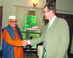Governor Aziz Qureshi shakes hands with British Deputy High Commissioner David Lelliott in Dehradun on Wednesday.