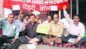 Employees of the Uttarakhand Forest Corporation stage a dharna in support of their demands in Dehradun on Wednesday.