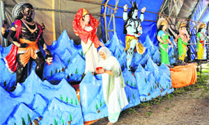 A woman at a pandal where idols for the nine-day Ganesh Mahotsav festival have been kept at Parade ground in Jammu.