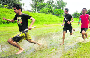 Athletes in action during the 400m relay race at the University of Jammu on Wednesday.