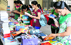 Youngsters take part in Bharat Jago Daud; and (right) students have a look at books during an exhibition at the Guru Nanak Khalsa College for Women, Gujarkhan campus, Ludhiana, on Wednesday