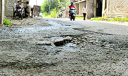 Potholed roads near Lakkar Pul and near DIG office in Civil Lines, Ludhiana