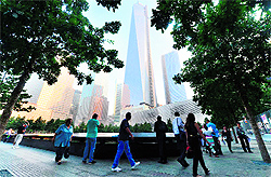 Friends and family members gather at the 9/11 Memorial on the 12th anniversary of the 9/11 attacks on the World Trade Center in New York on Wednesday