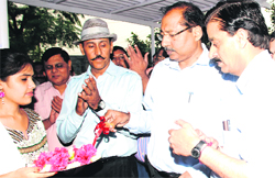 Chairman and Managing Director of the UHBVN and the DHBVN Devender Singh inaugurates the state's first model cash collection centre in Panchkula on Thursday. A Tribune Photograph 