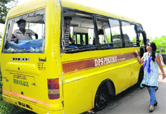 A teacher looks at the ill-fated bus of DPS Pinjore. tribune photo: manoj mahajan