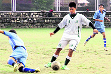 Players in action in a football match under way at St Josephs Academy in Dehradun on Thursday