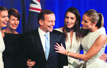 Despite low popular ranking, Conservative challenger Tony Abbott (seen with his family) staged a thumping win, thanks to Labour Partys internal feud. 