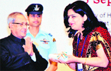 Himani Asija, Principal of DPS, Karnal, receives the National ICT Award by the President, Pranab Mukherjee, at Vigyan Bhawan, New Delhi. A Tribune photograph