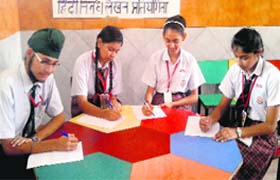 Students participate in a Hindi essay writing competition at DIPS School in Jalandhar on Thursday