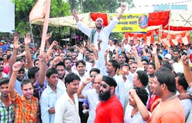 Members of Hindu Jagriti Manch block traffic at Nakodar Chowk in protest against a TV channel in Jalandhar on Thursday