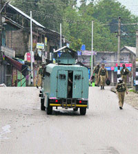 Security forces personnel patrol a street in curfew-bound Shopian district on Thursday. 