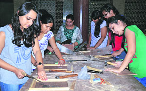 Girls pick up carpentry skills at the International Institute of Fashion Design in Ludhiana. 