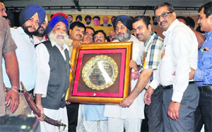 Punjab colonisers and property dealers honour Punjab Deputy Chief Minister Sukhbir Singh Badal during a function in Ludhiana on Thursday.