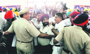Policemen keep the party supporters from approaching the stage at King Palace, Sunder Nagar, Ludhiana, on Thursday. 