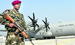 A security personnel keeps vigil near C-130-J aircraft at Hindon airbase