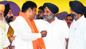 Deputy CM Sukhbir Badal presents a siropa to former district Youth Congress chief Dimpal Rana on his joining the SAD in Ludhiana on Thursday.