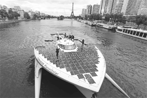 The Turanor PlanetSolar, worlds largest solar-powered boat, travels on the Seine river next to Eiffel Tower in Paris. PlanetSolar, a catamaran powered exclusively by solar energy, completed the first solar-powered trip around the world on May 4, 2012, after travelling over 60,000 km in 584 days.