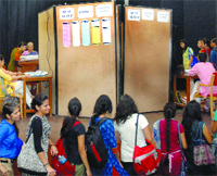 Students queue up to cast their vote for the DUSU election at Miranda College in New Delhi on Friday. 