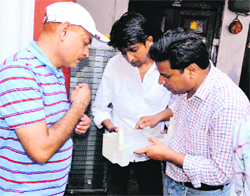 A Health Department team carries out an inspection at a dharamshala in Haridwar on Friday.
