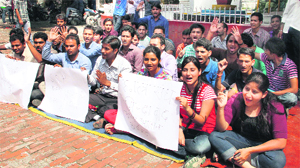 Students of DAV (PG) College hold a dharna against police lathi-charge on ABVP workers during the students council elections in Dehradun on Friday.