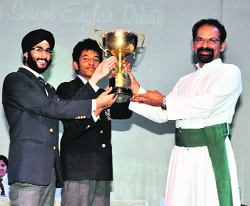 The team of St Georges College, Mussoorie, receives the JL D'Souza Memorial Inter-School Debate Trophy from Brother AJ George, Principal, St Jospehs Academy, in Dehradun on Friday. 