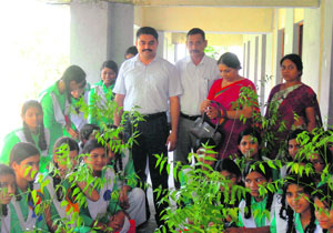 SP Singh, chairman of the Sardar Bhagwan Singh Institute of Bio-medical Sciences, presents saplings to students of Government Girls School at Balawala, near Dehradun, on Friday. 