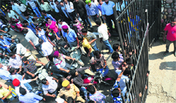Employees and students outside the Jammu University gates as protesting students locked it for hours in Jammu on Thursday. A Tribune photograph