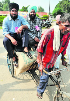 Farmers carry bags of seeds on a rickshaw