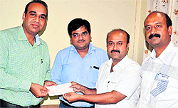 Sanjay Kapoor, CA, hands over a cheque for Rs 3.56 crore to Improvement Trust Chairman Sandeep Rishi in Amritsar