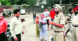 A Municipal Corporation team gets an illegal dairy vacated near Dasehra ground in Amritsar on Saturday