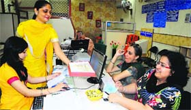 A staff member shares sweets on the inauguration of the all-women branch of the State Bank of Patiala in Chandigarh on Saturday.