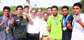 Members of the GGDSD College-32 team strike a pose after winning the overall Inter-College Swimming Championship at Panjab University.