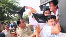 The police arrests senior BJP leader Harmohan Dhawan and his supporters as they wave black flags at the Sector 26 light point in Chandigarh on Saturday.