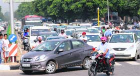 Vehicles stuck for some time in a traffic jam at the Sector 26 transport light point in Chandigarh on Saturday. Many commuters, on realising the roads had been blocked, returned or took alternative routes to reach their destinations.