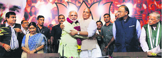 BJP President Rajnath Singh greets Gujarat Chief Minister Narendra Modi after declaring him the party's prime-ministerial candidate for 2014 Lok Sabha polls, in New Delhi on Friday. Party leaders Sushma Swaraj, Arun Jaitley, Nitin Gadkari and MM Joshi look on.
