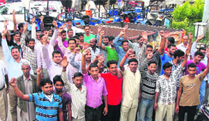 Tractor-trailer owners protest against the state government in front of the DC office in Dharamsala on Saturday. 