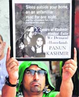 A man holds a placard during an event organised to observe Martyrs Day in Jammu on Saturday.