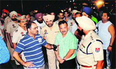 Police Commissioner Ram Singh (blue T-shirt) inspects the site where two groups opened fire in Jalandhar on Saturday night.