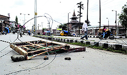A barbed wire fence erected on a road in Shopian on Saturday