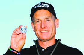 Jim Furyk holds up his ball with a '59' on it after shooting a round of 59 in the BMW Championship on Friday