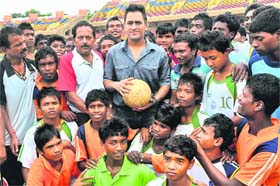DHONI PLAYS BALL: MS Dhoni with young players during a football tournament at Birsa Munda Stadium in Ranchi on Saturday