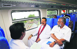 Lankan President Rajapakse (C) on board the 'Yal Devi' train. AFP