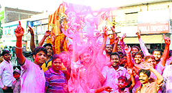 Devotees carry an idol of Lord Ganesha to submerge it in a water channel on Sunday