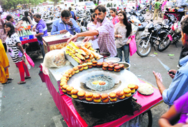 A roadside vendor sells eatables on a busy street in Sector 22, Chandigarh.