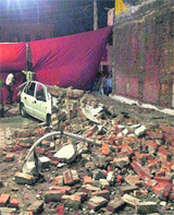 A car which was damaged due to the collapse of a wall of a petrol pump following high-speed winds and rain on the Nakodar road in Jalandhar on Sunday evening. 