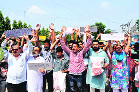 Residents hold a protest against the CAPD for its failure to issue ration in Jammu on Sunday.