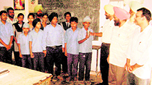 Manager of the Dehlon branch of the SBI Sher Singh offers water to a student at Ghungrana near Ahmedgarh