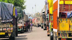 Several trucks parked on the roadside