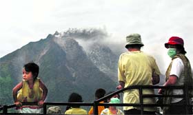 Villagers wait to be evacuated as Mount Sinabung spews lava in Karo district, Indonesia, on Sunday.